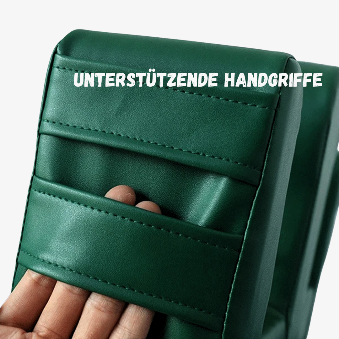 Grüne Umlagerungshilge mit mehreren Handgriffen für sicheren Halt, eine Hand greift in die ergonomisch gestalteten Griffe.